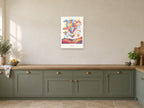 Up We Go — Sky Carnival Children’s Art Print at A2, in a white frame, in a kitchen