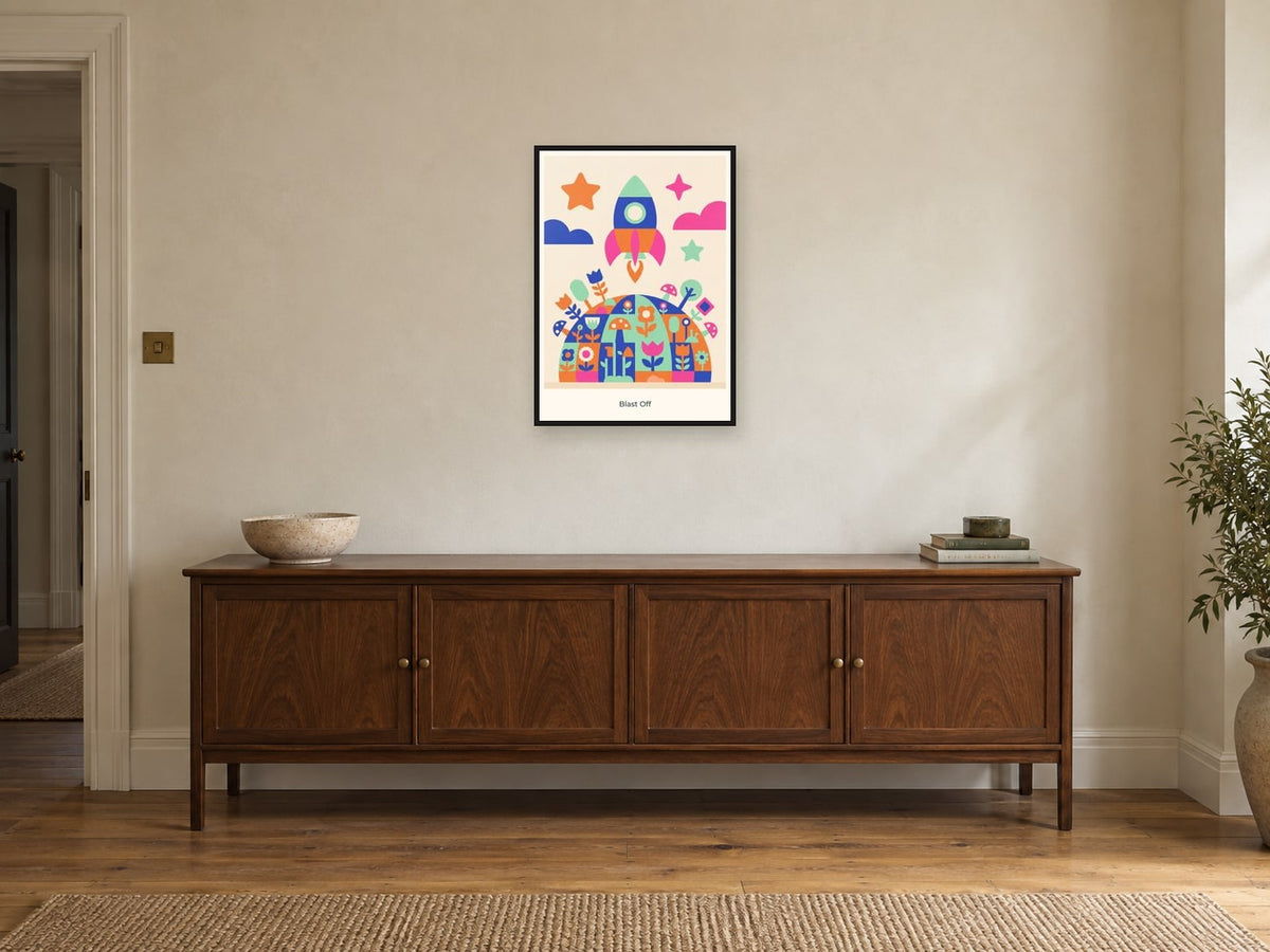 Blast Off — Playful Little Planet Children’s Art Print at A2, in a black frame, above a sideboard