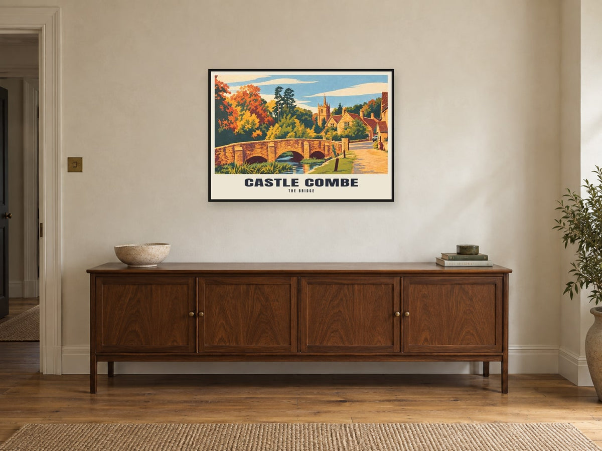 The Bridge, Castle Combe Poster at A1, in a black frame, above a sideboard