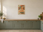 Twirl at the Table — A2 artwork shown in a room with a natural wood frame; select a framed finish to include a frame