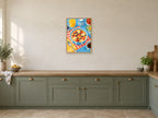 Breakfast at the Blue Table — A2 artwork shown in a room with a natural wood frame; select a framed finish to include a frame