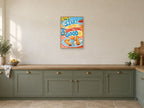 Start with Something Good — A2 artwork shown in a room with a natural wood frame; select a framed finish to include a frame