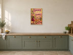 Dinner Is Better with Stories — A2 artwork shown in a room with a natural wood frame; select a framed finish to include a frame
