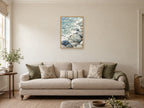 Tide Through Pebbles — A2 artwork shown in a room with a natural wood frame; select a framed finish to include a frame