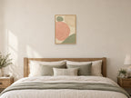 Two Stones in Balance — A2 artwork shown in a room with a natural wood frame; select a framed finish to include a frame