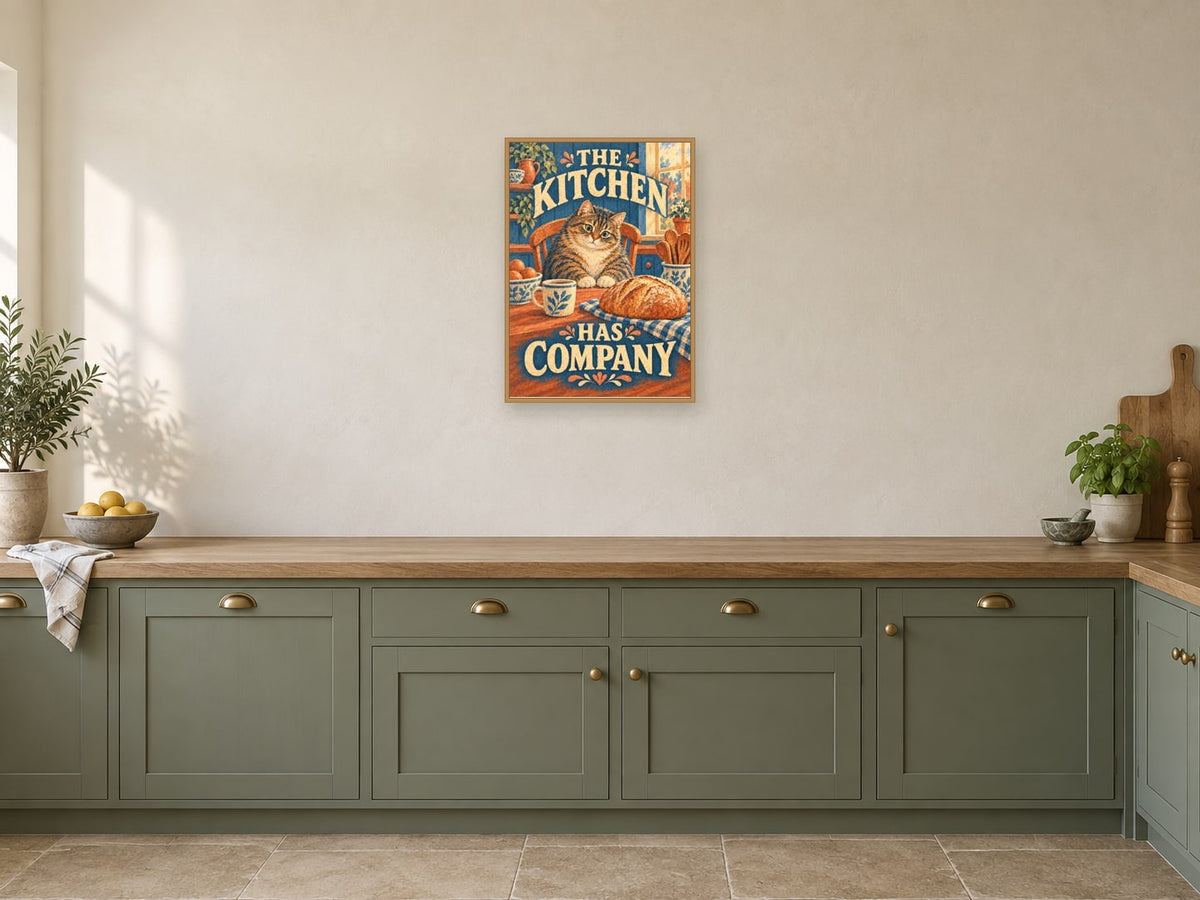 The Kitchen Has Company — A2 artwork shown in a room with a natural wood frame; select a framed finish to include a frame