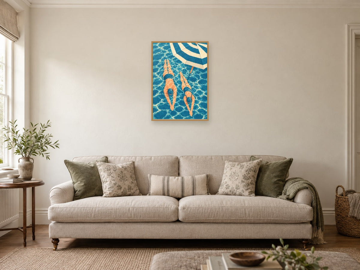 Two swimmers passing — A2 artwork shown in a room with a natural wood frame; select a framed finish to include a frame