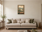 Rain passing over an imagined valley — A2 artwork shown in a room with a natural wood frame; select a framed finish to include a frame