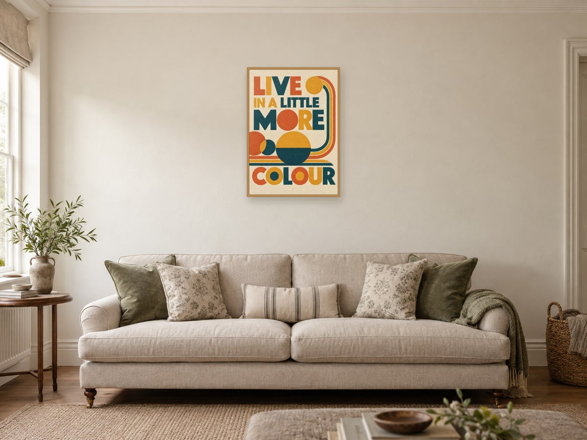 Live In A Little More Colour — A2 artwork shown in a room with a natural wood frame; select a framed finish to include a frame