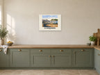 Ilfracombe named Gouache print at A2, in a white frame, in a kitchen
