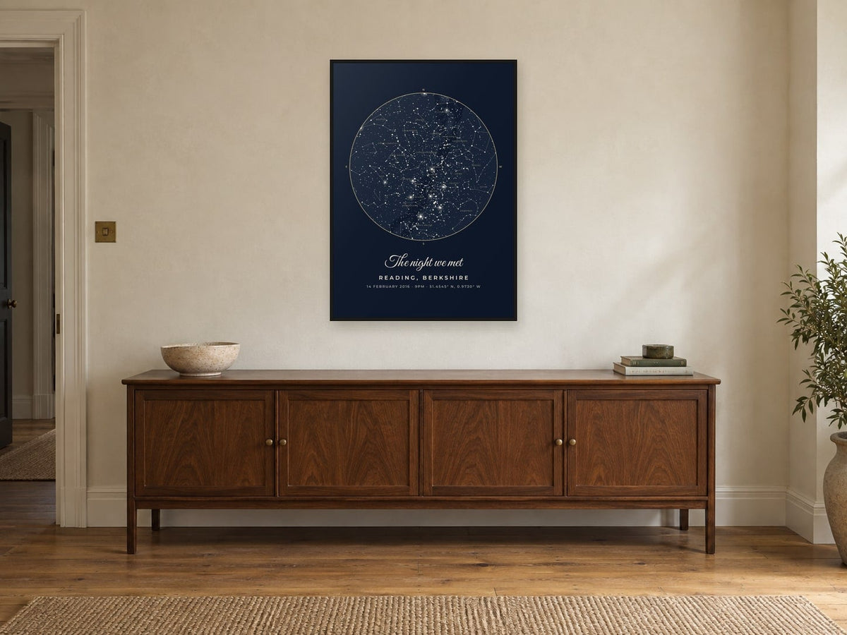 Star map of the sky over Reading in the Midnight design, in a black frame, above a sideboard